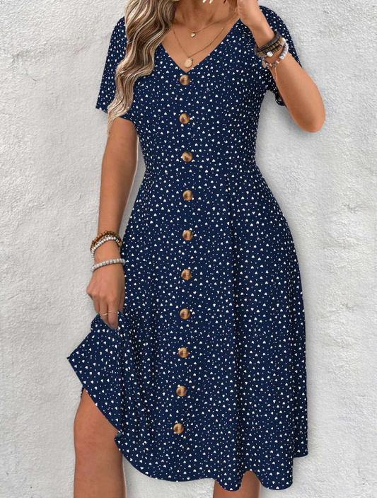 Vestido azul marino con mangas cortas, escote en V y estampado de lunares